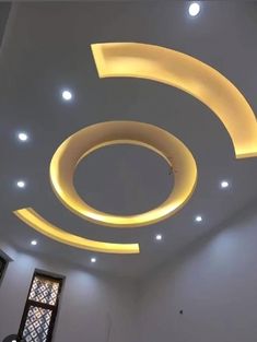 the ceiling is decorated with white lights and circular shapes on it's sides, along with an arched window