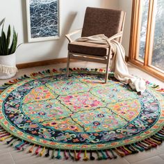 a round rug with fringes on the floor next to a chair and potted plant