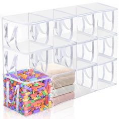 a stack of clear plastic bins filled with lots of different colored candies