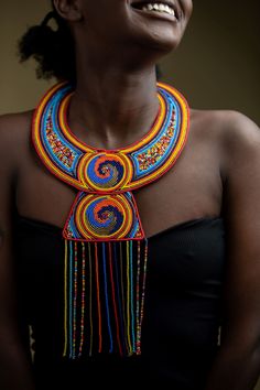 Unique Africa Maasai Handcrafted Leather Beaded Necklace with an Elegant Look and Brilliant Finish. Color = Multi-Color. Length (Around Neck) =Adjustable. Length ( Downwards ) = 14 Inches / 37 Centimeters. **GET FREE SHIPPING FOR ADDITIONAL ITEMS PURCHASED. Yes, Buy Multiple Items and pay shipping for 1 item only- The rest ships Free. (No Limits on the number of Multiple items).  With a faster delivery time of 3 days via DHLExpress, Worldwide. Ordinary/Standard Shipping also available upon request.  We Custom Make to Suit Your Taste. Available In All Colors and Sizes. For wholesale please chat me up for discounted rates. Africa jewelry for women. Kenya Beaded Necklace. Leather Necklace. Zulu Necklace. Tribal Necklace. Ethnic Necklace. Ankara Necklace In case of any question feel free to ch Massai Jewelry, African Beaded Necklace, Pokemon Jewelry, Leather Beaded Necklace, African Beads Necklace, Beautiful Beaded Necklaces, Beautiful Beaded Jewelry, Multi Coloured Necklaces, African Earrings