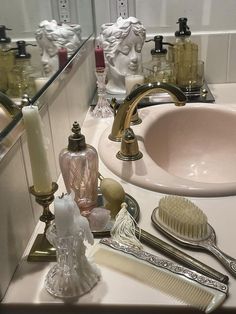 a bathroom sink filled with lots of different types of hairbrushes and combs