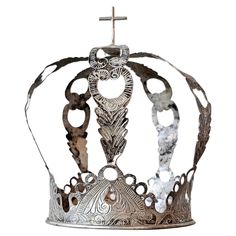 a metal crown with an ornate design on it