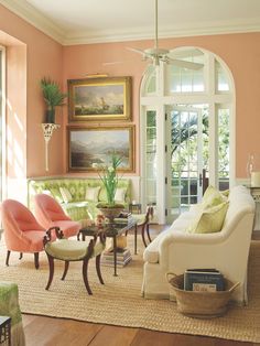 a living room filled with lots of furniture and decor on top of a hard wood floor