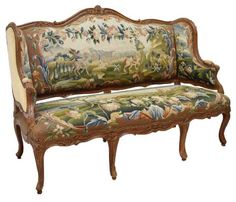 an ornately decorated bench with floral tapestry on the back and arms, sitting against a white background