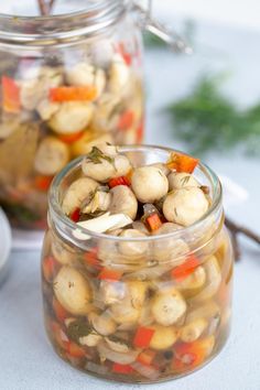 two jars filled with food sitting on top of a table