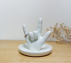 a white ceramic peace sign sitting on top of a wooden table