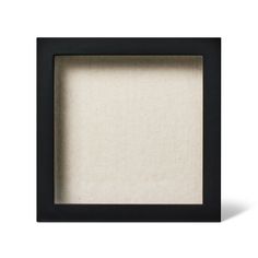 an empty black frame with white linen inside on a white background for text or image