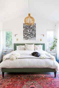 a dog laying on top of a bed in a bedroom