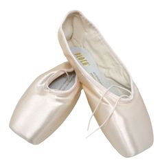 two white ballet shoes with laces on them