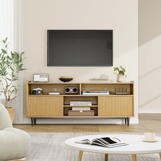 a flat screen tv mounted to the side of a wooden entertainment center in a living room