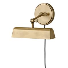 an antique brass finish wall light with a black cord on the side and a white background