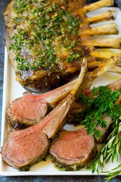 steak, french fries and parsley on a white plate with green garnish