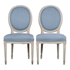 two chairs with blue upholstered back and white trimmings, side by side