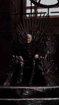 an older man sitting on the iron throne