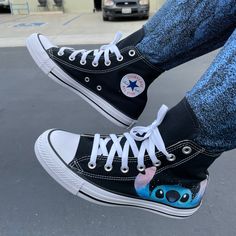 These custom Dandingeroz shoes come in Black High Top Converse. Both shoes have the Adorable Moonlight Series Stitch peeking out from the mid-sole of the Converse. Stitch will be on the outside of both shoes. These shoes are perfect for your relaxing stroll on the beaches of Hawaii or any Disney Lilo and Stitch fanatic! Dan Elijah G. Fajardo is a Manila based artist who is the creative mind and owner behind Dandingeroz. Fajardo has mastered his art style and technique through illusion design usi Lilo And Stitch Merchandise, Black High Top Converse, High Top Converse, Ohana Means Family, Cute Stitch, Black High Tops, Disney Lilo, Converse Sneakers, Stitch Disney