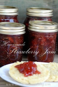 homemade strawberry jam is on a plate next to crackers and jelly in mason jars