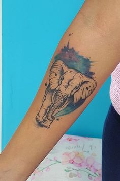 an elephant tattoo on the arm