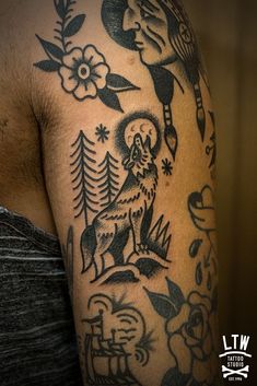 a close up of a person's arm with tattoos on it