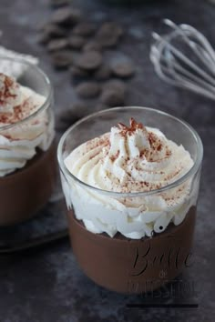 two dessert cups with whipped cream and chocolate