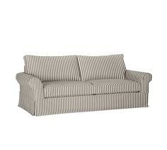 a striped couch sitting on top of a white floor