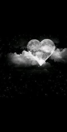 black and white photograph of heart in the clouds with stars on it's side