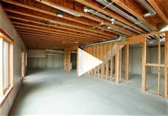 an empty room with unfinished walls and wooden beams on the ceiling is shown in this video