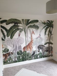 a room with wallpaper that has zebras and giraffes on it