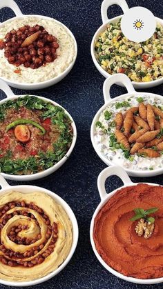 a table topped with lots of different types of food and dips on top of it