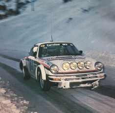 a car driving down a snow covered road