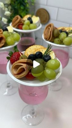 fruit and crackers sit on top of wine glasses