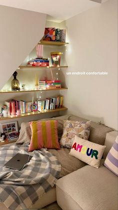 a living room filled with lots of furniture and bookshelves next to a wall