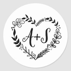 a heart shaped sticker with the word ats in black and white, surrounded by leaves