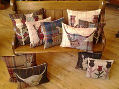 four decorative pillows on a bench in a living room