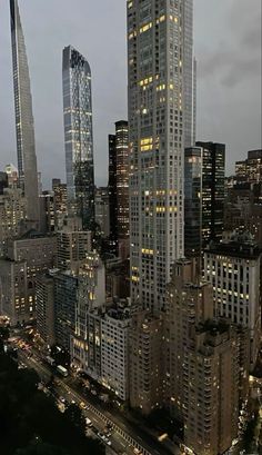 an aerial view of skyscrapers at night in new york city, with lights on