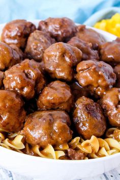 a white bowl filled with meatballs and noodles