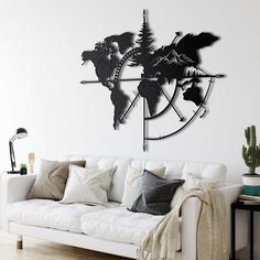 a living room with a white couch and large metal clock