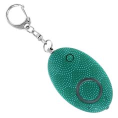 a green keychain with an oval shaped object on it's front end