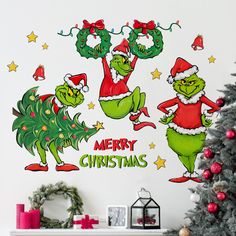 the grinch christmas wall decals are on display in front of a decorated christmas tree