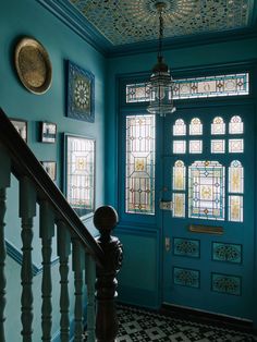 a blue front door with stained glass windows