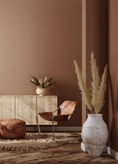 a living room with brown walls and furniture in the corner, including two chairs and a vase