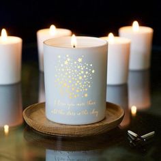 some white candles with gold stars on them