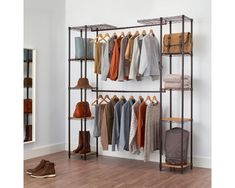 an iron rack with clothes and shoes on it in a room next to a mirror