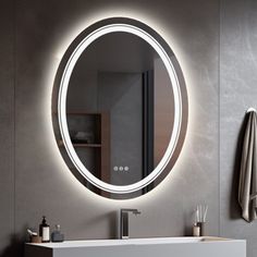 a bathroom with a sink, mirror and towel rack