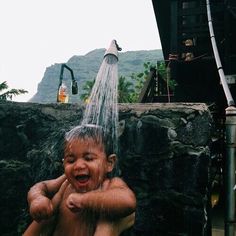 a young boy is playing in the water