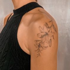 a woman with a tattoo on her shoulder