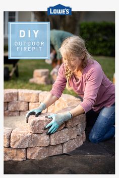 a woman placing bricks into a fire pit with gloves on her hands and the words diy outdoor firepit above it