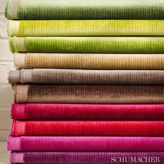 a stack of different colored fabrics on top of each other, all in different colors