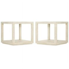 two white wooden shelves sitting next to each other