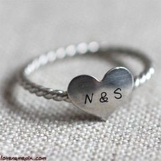 a heart shaped ring with question marks on it's side and the word love is written