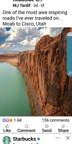 an image of a road going down the side of a mountain next to a body of water